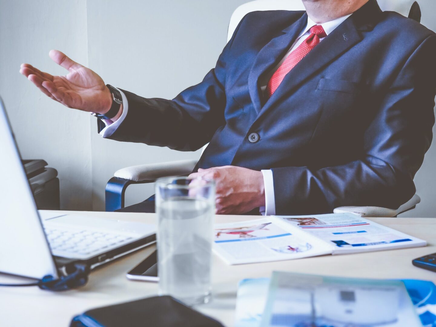 A man in a suit sitting at a desk